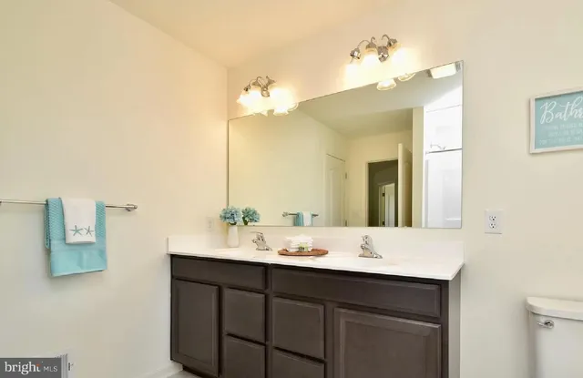 a bathroom with a double vanity sink and a mirror