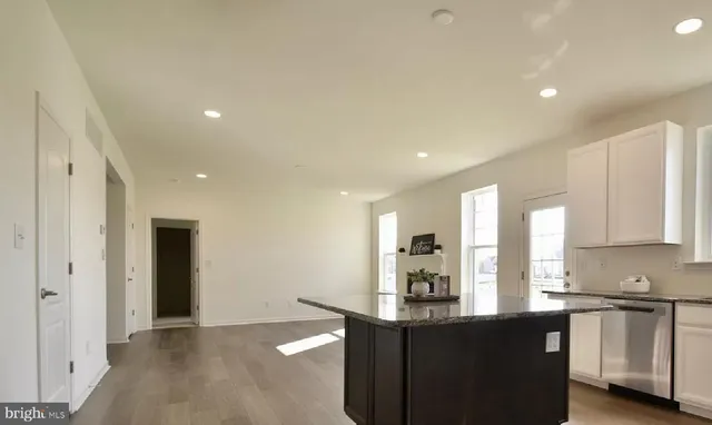 a kitchen with stainless steel appliances granite countertop a sink and cabinets