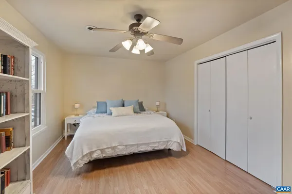 a bedroom with furniture and a book shelf