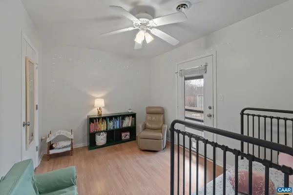 a bedroom with furniture and wooden floor