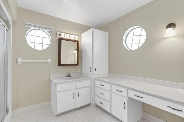 a white toilet sitting next to a bathroom sink