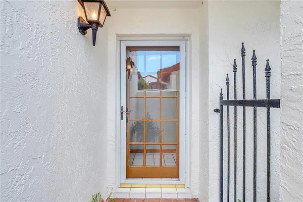 a view of a hallway with wooden floor and entryway