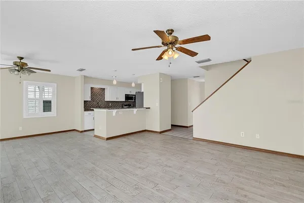 a view of a kitchen with furniture and a ceiling fan