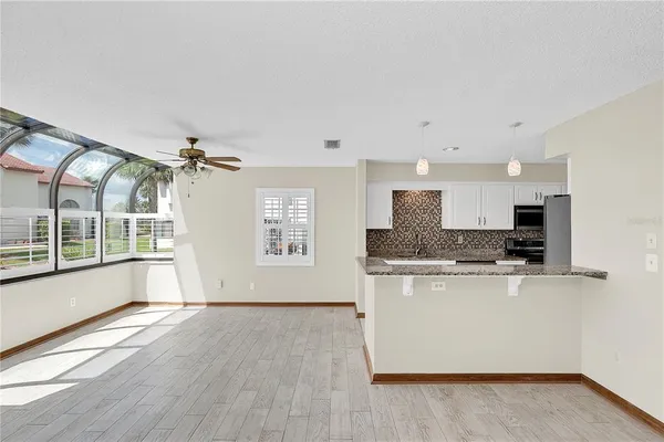 a view of kitchen with stainless steel appliances granite countertop a stove top oven a sink and a refrigerator