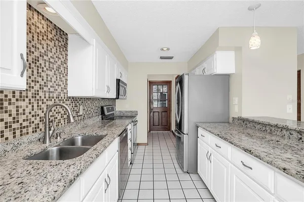 a kitchen with a sink stove and refrigerator