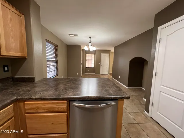 a kitchen with a sink a counter space and a window