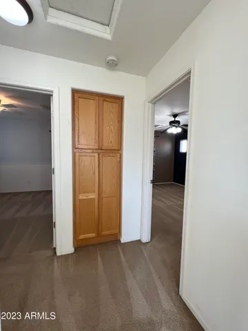 a view of a room with wooden floor cabinet and a bathroom
