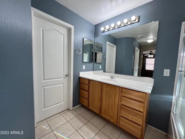 a bathroom with a double vanity sink and a mirror