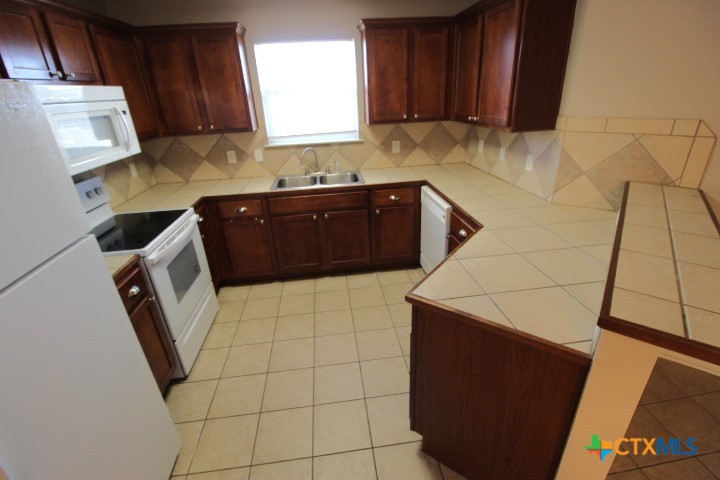 1804 Walker Pl Boulevard Copperas Cove, TX 76522 - Photo 5 of 12 a kitchen with a sink a stove and cabinets