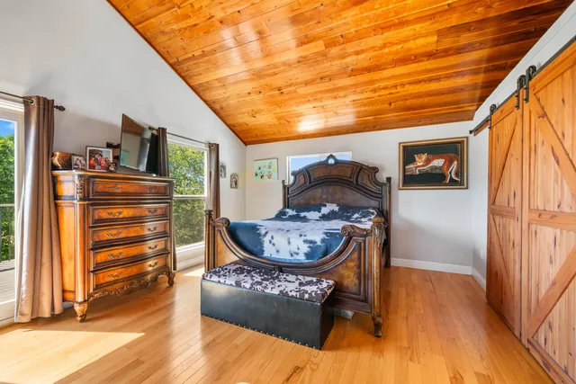 a front view of a house with a garden and deck