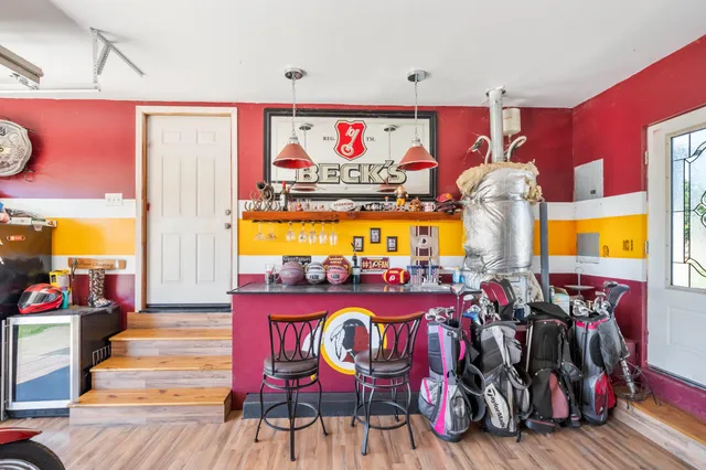 an aerial view of residential houses with outdoor space and trees