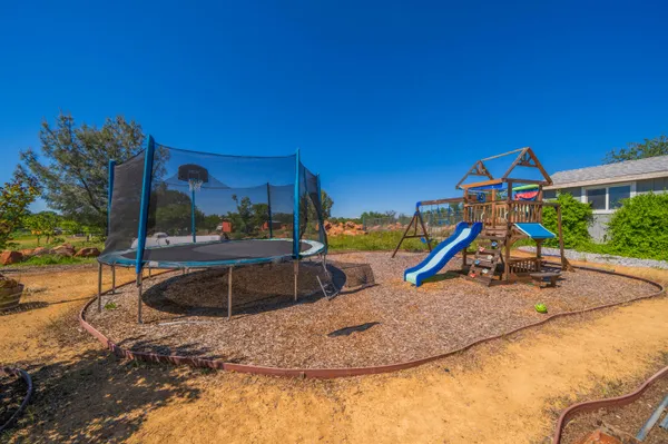 a view of a swimming pool and trees in the background