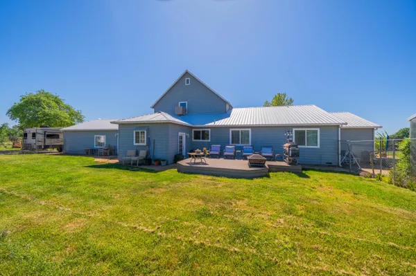 an aerial view of a house with a yard