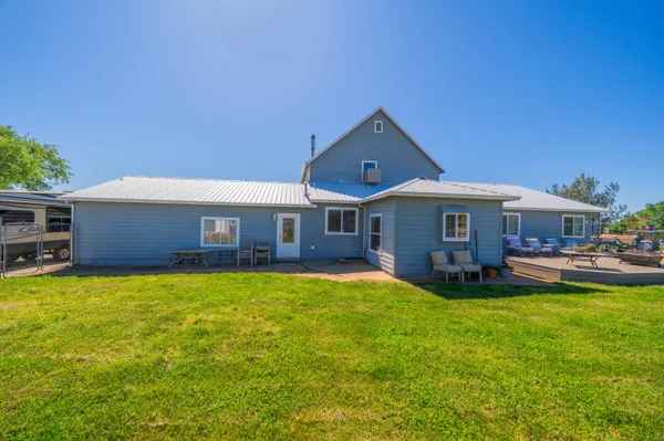 an aerial view of a house with garden space and street view