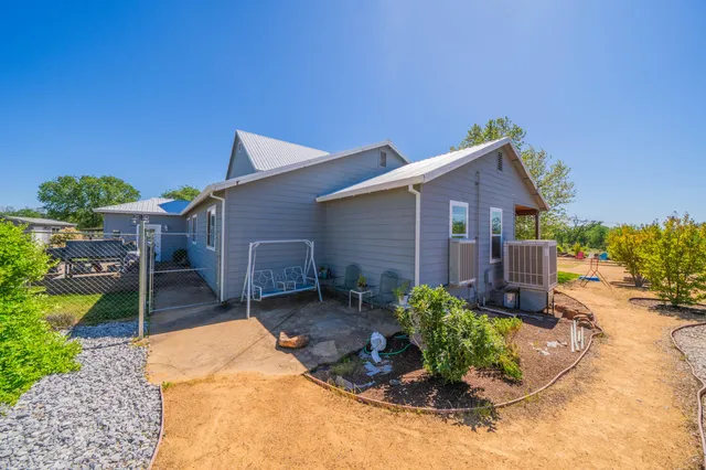 an aerial view of a house with a garden and lake view