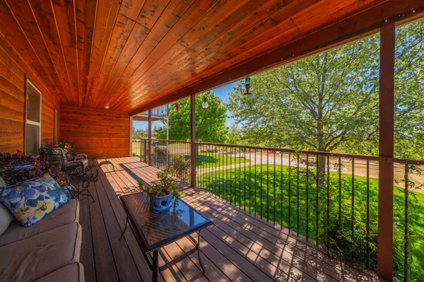 a view of a wooden deck with a yard