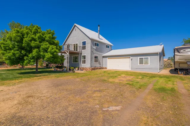 an aerial view of a house with a yard lake view and mountain view