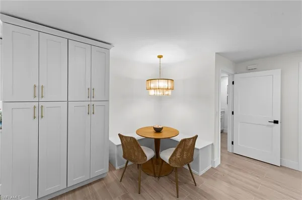 a view of a room with furniture and wooden floor