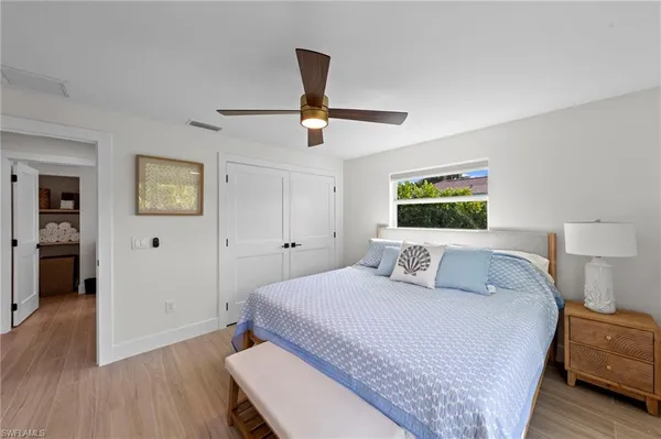 a bedroom with a large bed and a chandelier