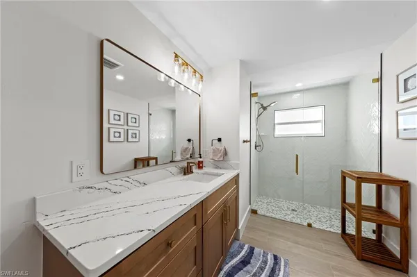 a bathroom with a sink double vanity and shower