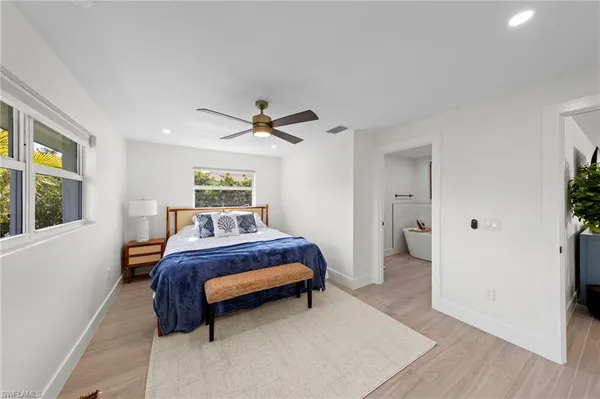 a bathroom with a white tub shower and toilet
