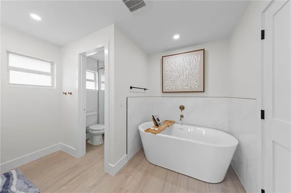a spacious bathroom with a double vanity sink and a mirror
