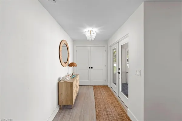 a view of a hallway with wooden floor and staircase