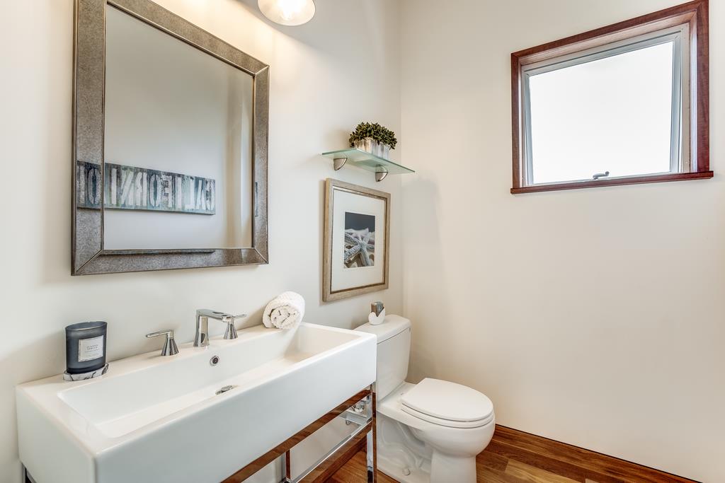 61 Elder Lane Pacifica, CA 94044 - Photo 13 of 37 a bathroom with a toilet a sink and mirror