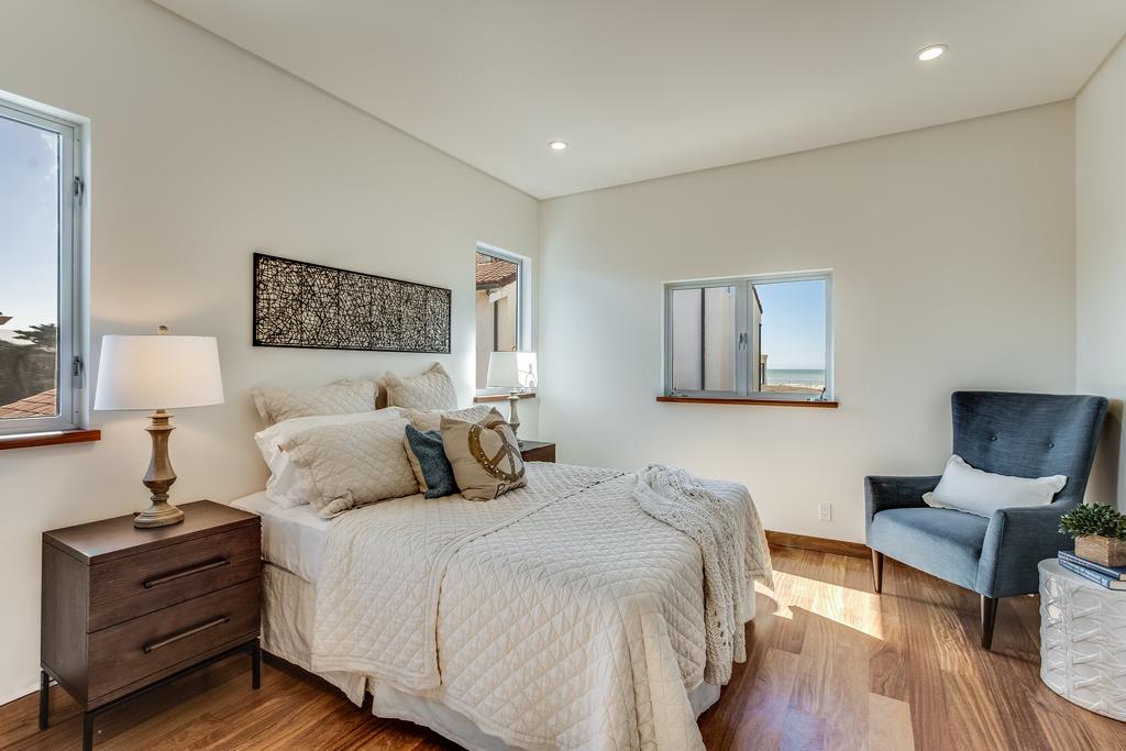 61 Elder Lane Pacifica, CA 94044 - Photo 14 of 37 a bedroom with a bed and a chair