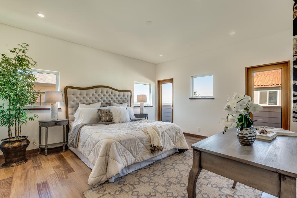 61 Elder Lane Pacifica, CA 94044 - Photo 15 of 37 a bedroom with a bed and a table in it
