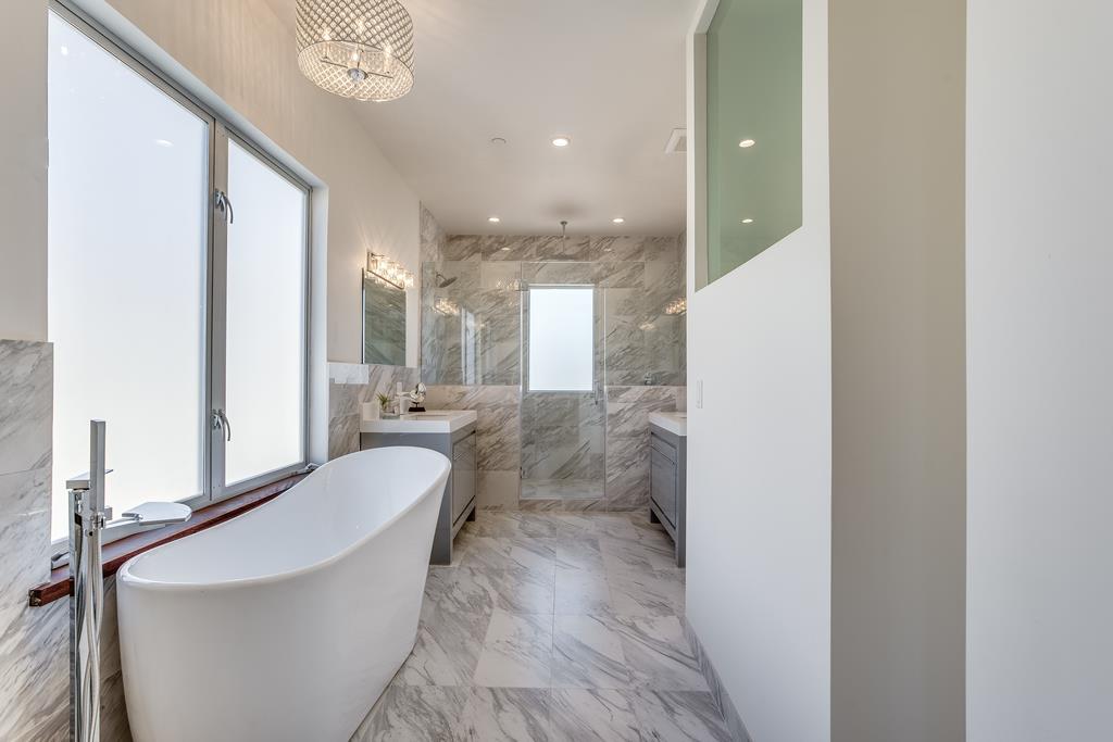 61 Elder Lane Pacifica, CA 94044 - Photo 17 of 37 a bathroom with a bathtub shower sink and mirror