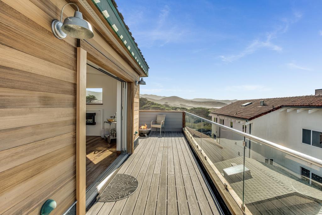 61 Elder Lane Pacifica, CA 94044 - Photo 24 of 37 a view of balcony and deck with wooden floor and fence