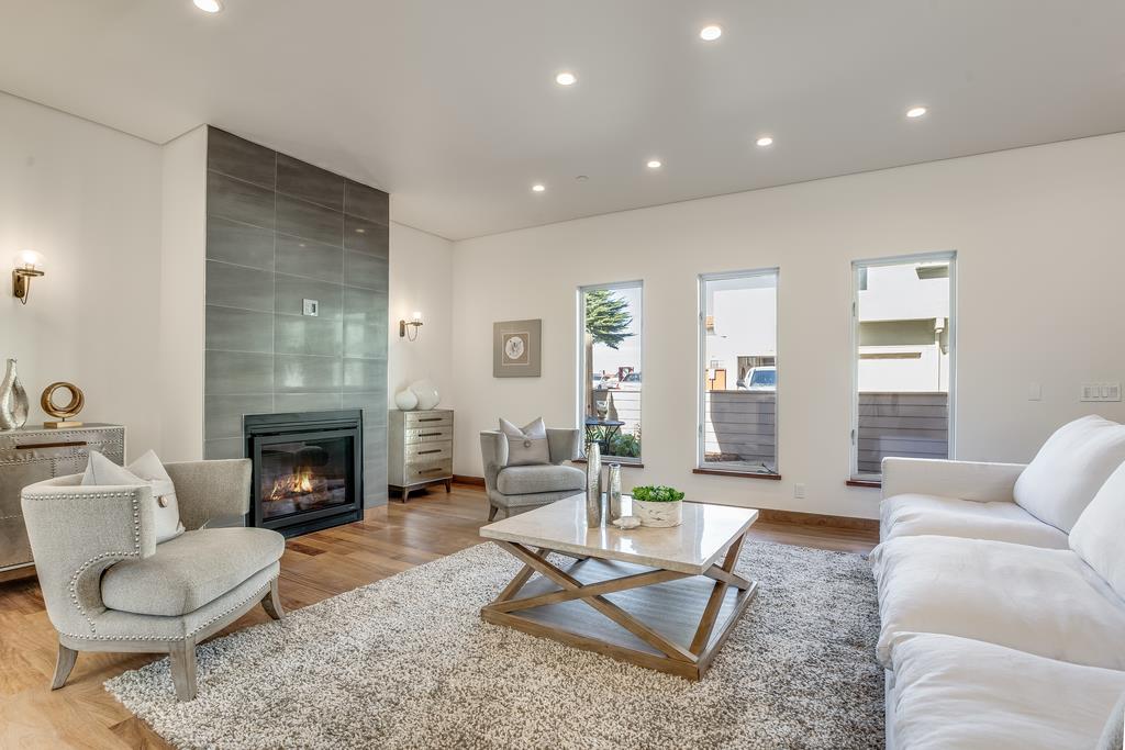 61 Elder Lane Pacifica, CA 94044 - Photo 5 of 37 a living room with furniture a fireplace and a table
