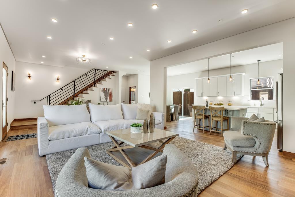 61 Elder Lane Pacifica, CA 94044 - Photo 6 of 37 a living room with furniture kitchen view and a wooden floor
