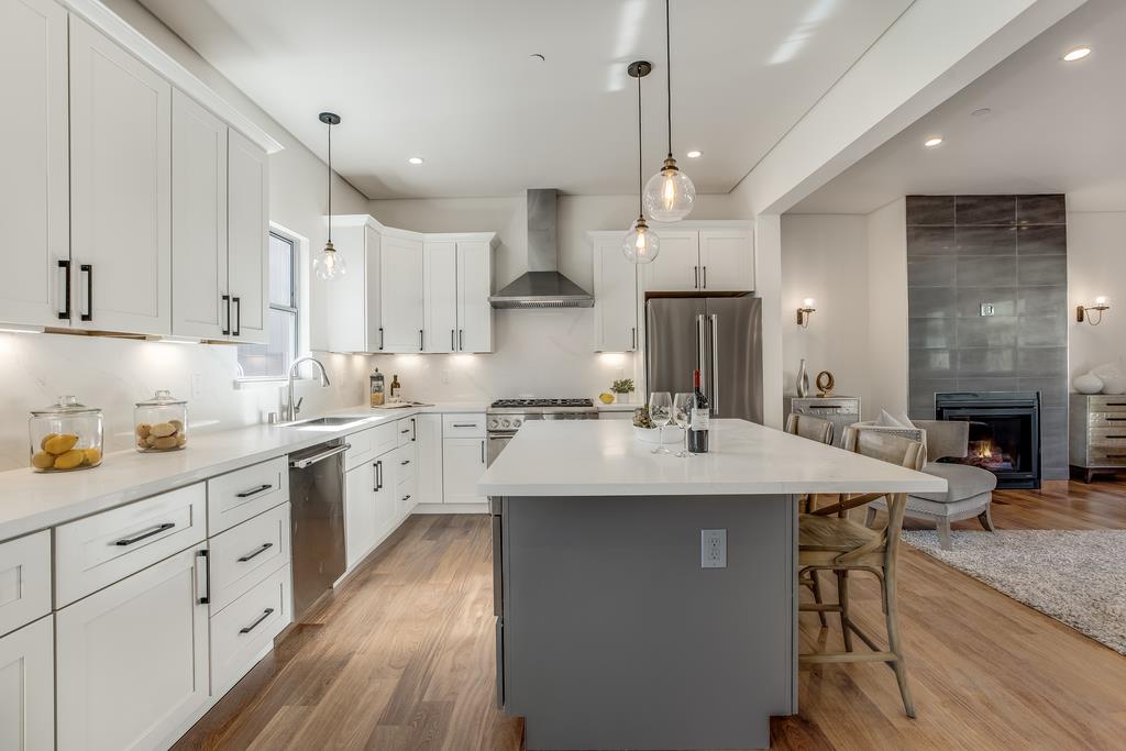 61 Elder Lane Pacifica, CA 94044 - Photo 10 of 37 a kitchen with granite countertop a sink a center island stainless steel appliances and cabinets