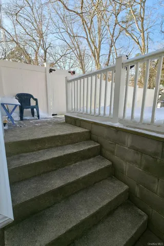 a view of backyard with wooden fence and a large tree