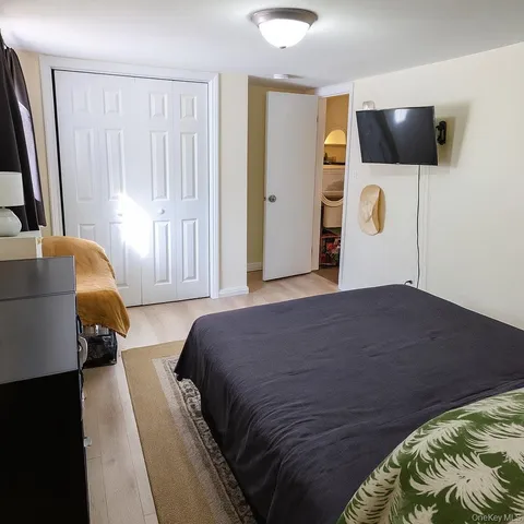 a bedroom with a bed and flat screen tv