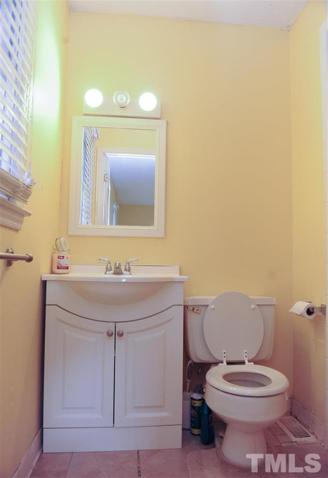 3012 Oldham Court Raleigh, NC 27604 - Photo 16 of 19 a bathroom with a toilet a sink and mirror