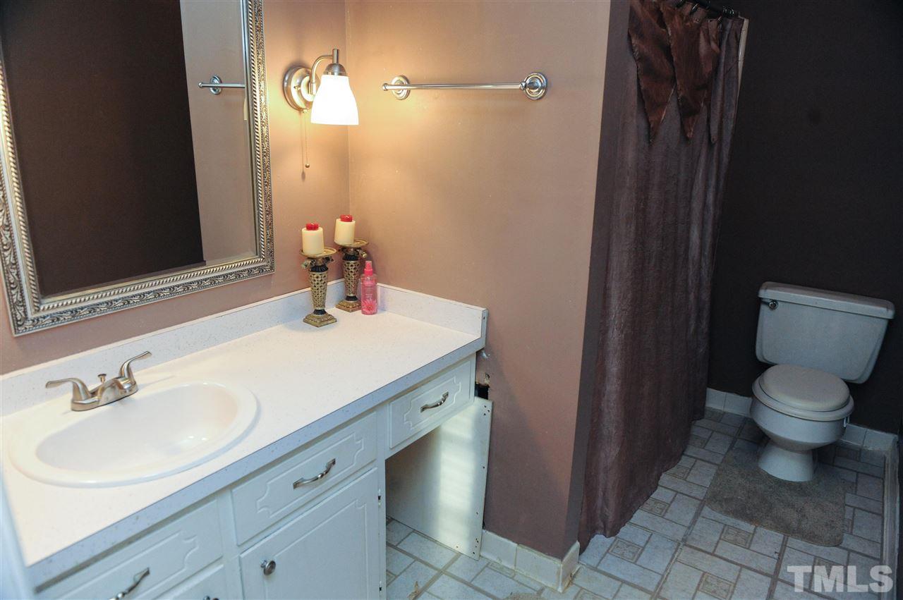3012 Oldham Court Raleigh, NC 27604 - Photo 17 of 19 a bathroom with a toilet sink and mirror
