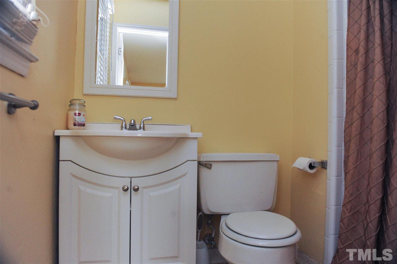 3012 Oldham Court Raleigh, NC 27604 - Photo 19 of 19 a bathroom with a sink a toilet and mirror