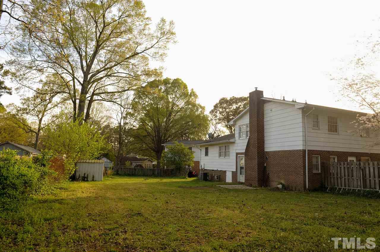 3012 Oldham Court Raleigh, NC 27604 - Photo 3 of 19 a backyard of a house with plants and large tree