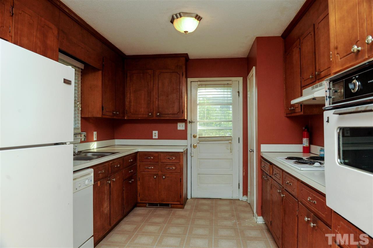 3012 Oldham Court Raleigh, NC 27604 - Photo 5 of 19 a kitchen with stainless steel appliances granite countertop a refrigerator and a stove top oven