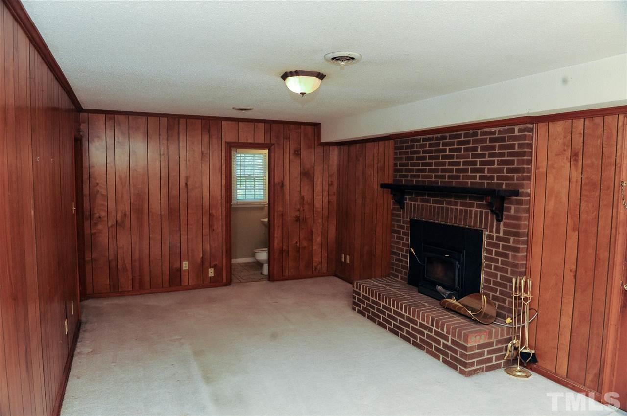 3012 Oldham Court Raleigh, NC 27604 - Photo 10 of 19 a view of an empty room with brick walls and a fireplace