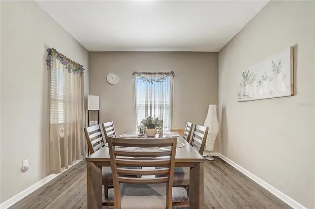 a dining room with furniture and wooden floor