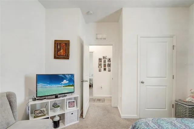 a bedroom with two beds and large window
