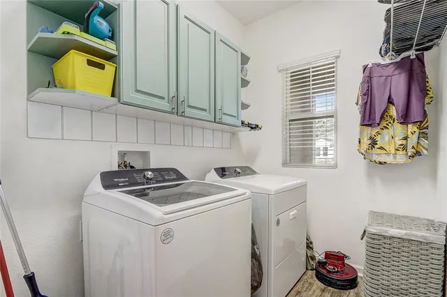 a spacious bedroom with a bed and a chandelier