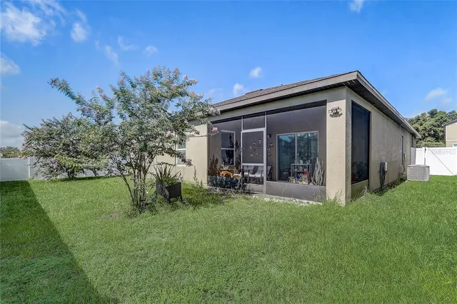 a view of a porch with furniture and floor to ceiling window