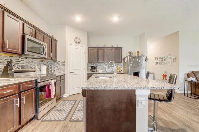 a kitchen with stainless steel appliances granite countertop a sink and cabinets