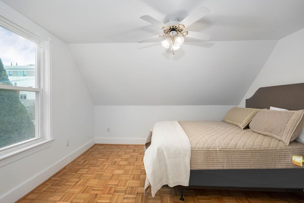 79 Brookline Street Lynn, MA 01902 - Photo 19 of 27 a bedroom with a bed and a chandelier