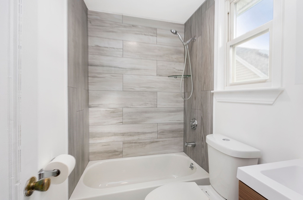 79 Brookline Street Lynn, MA 01902 - Photo 22 of 27 a bathroom with a bathtub and a shower